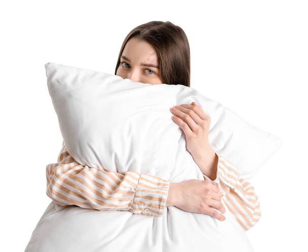 Young woman with soft pillow on white background - Fotoğraf, Görsel