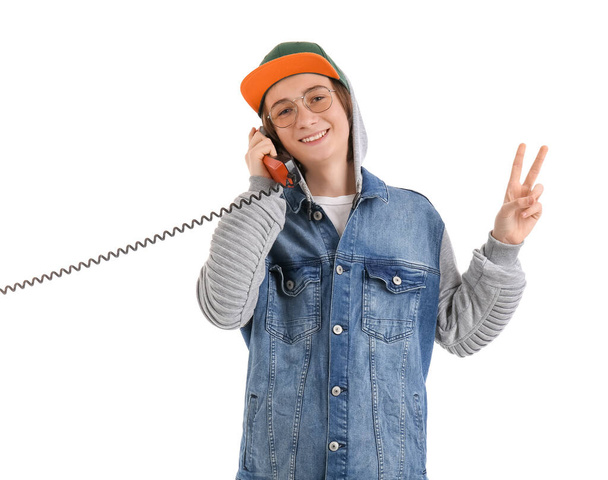Cool teenage boy talking by telephone on white background - Foto, afbeelding