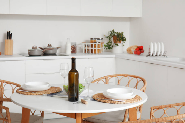Served dining table in interior of light kitchen - Photo, Image
