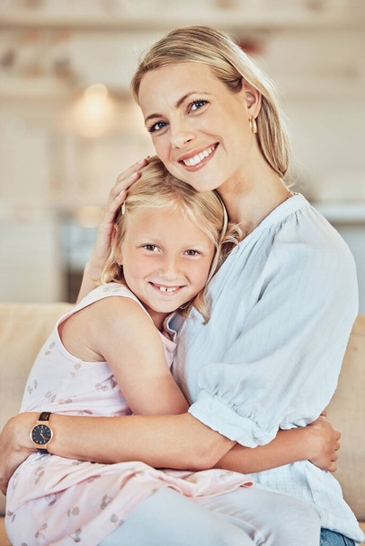 Portrait, woman and hug girl kid in home for love, care and quality time together on mothers day. Happy mom, family and hugging cute daughter for support, comfort and smile to relax in loving house. - Fotó, kép