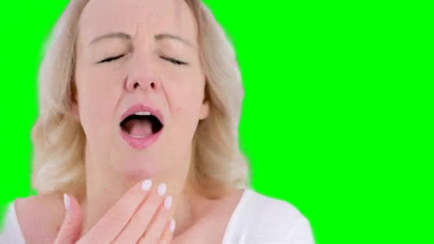 slow motion seasonal allergy cold dry air close-up woman sneezes covering her hand on white background water eyes licks lips unpleasant sensation - Filmagem, Vídeo