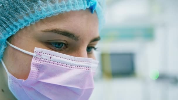 o rosto de um cirurgião triste em uma máscara estéril que não poderia salvar o paciente durante uma operação em sala de cirurgia close-up - Filmagem, Vídeo