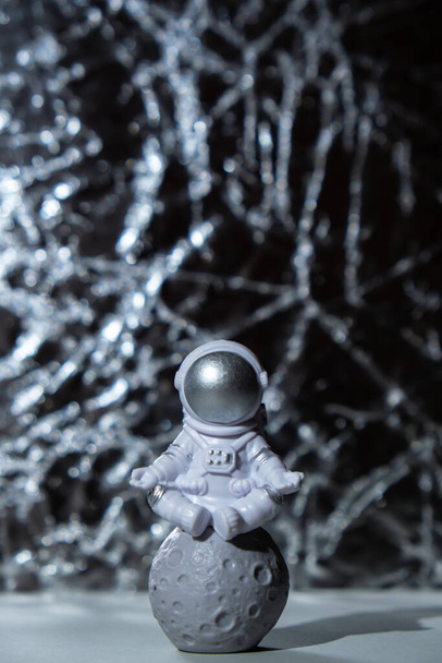 Plastic toy figure astronaut on silver background Copy space. Concept of out of earth travel, private spaceman commercial flights. Space missions and Sustainability - Foto, Imagen