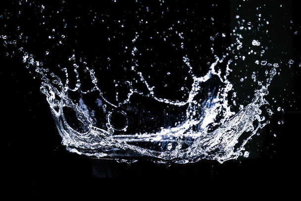 Splashing water on a black background. water splash refreshing black background - Foto, imagen