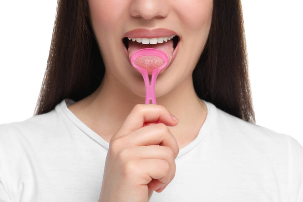 Woman brushing her tongue with cleaner on white background, closeup - Fotó, kép