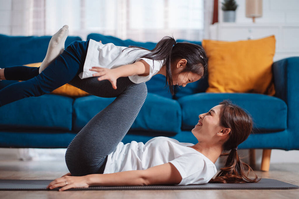 Mother and daughter exercising together happily at home. for flexibility build muscle strength, Sport workout training family together concept. - Fotografie, Obrázek