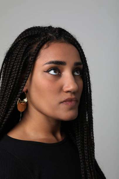African American young woman with long dark braids, posing at studio. Mock-up. High quality photo. - Φωτογραφία, εικόνα