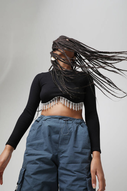 African American young woman with long dark braids, posing at studio. Mock-up. High quality photo. - Fotó, kép