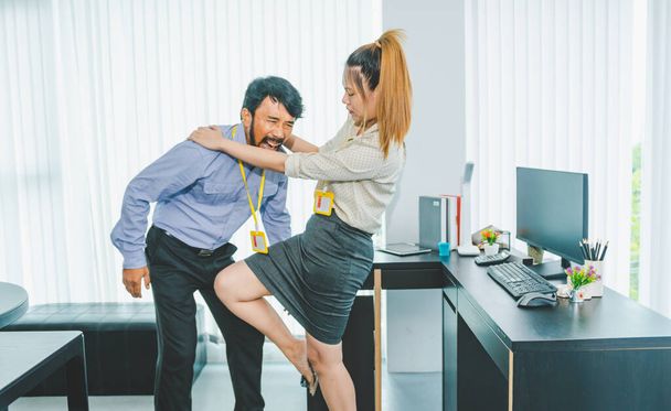 female employee is protecting herself from her boss or supervisor who is sexually harassing her for fear of being sexually harassed. There is sexual harassment in the workplace. - Photo, Image
