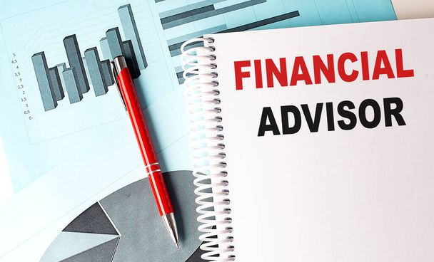 FINANCIAL ADVISOR text on notebook with pen on a chart background - Photo, Image