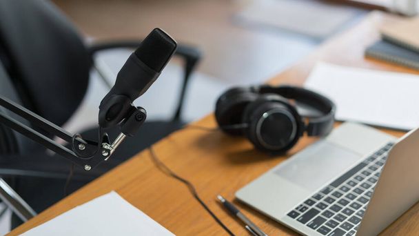 Podcast studio in home with laptop headphones and microphone for making and recording audio podcast. - 写真・画像