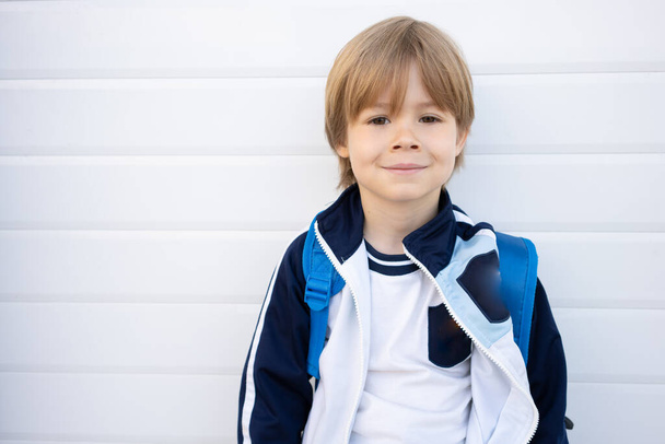 Portrait of 4 years old boy looking at camera with beautiful brown eyes and smiling face, Excited kid carrying backpack get ready to go to for adventure with school summer camp - Photo, image