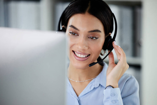 Customer service, woman with a headset and computer at her desk of her modern office workplace. Online communication or crm, support or telemarketing and female call center agent at her workspace. - Foto, Bild