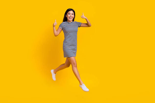 Full length photo of adorable positive lady wear trendy clothes run store hurry discounts empty space isolated on yellow color background. - Photo, image
