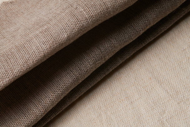 Linen in different textures and colors. Natural fabrics from organic flax and cotton in rolls, homespun textile handmade. Burlap and canvas for eco, rustic, boho, hygge decor - Photo, Image