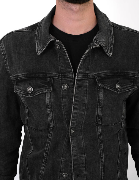 chaqueta clásica de mezclilla negro en un primer plano hombre sobre un fondo blanco - Foto, imagen