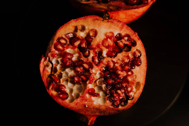 Pomegranate fruit. Fresh and ripe Pomegranates rotating over black Background. Organic Bio fruits closeup. Diet, dieting concept. - Fotoğraf, Görsel