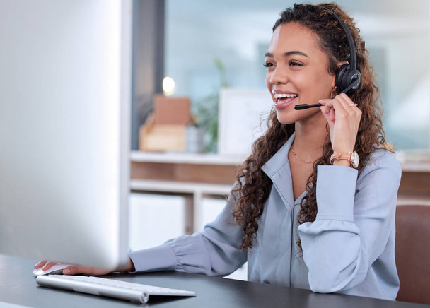 Call center, computer and a woman consulting in her office for telemarketing, sales or assistance. Customer service, support and crm with a happy young female employee working online using a headset. - Фото, зображення