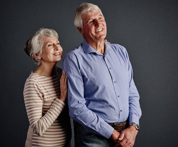 Theyve still got a long life ahead. Studio shot of an affectionate senior couple posing against a grey background - Foto, afbeelding