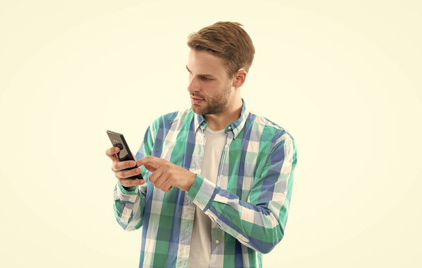 man texting on phone wear checkered shirt. photo of man texting on phone device. man texting on phone isolated on white background. casual man texting on phone in studio. - Foto, immagini