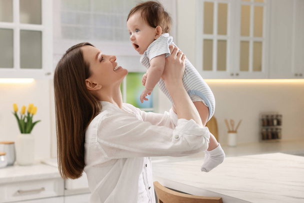 Happy mother with her little baby in kitchen at home - Photo, Image