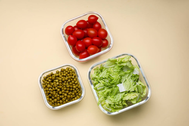 Glass containers with different fresh products on beige background, flat lay - Photo, Image