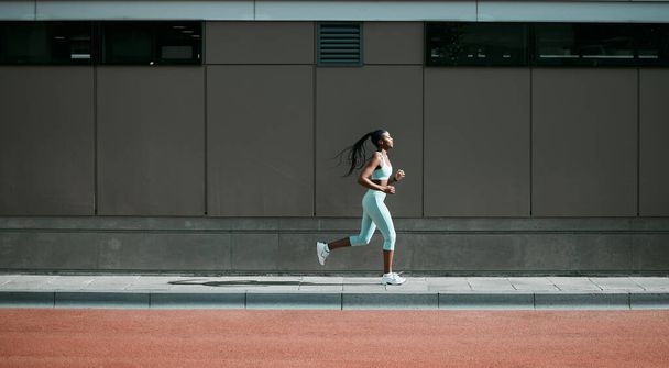 Black woman, running and city sport on sidewalk with training, exercise and fitness on road. Street, urban runner and female athlete with mockup and body workout for health, wellness and race outdoor. - Zdjęcie, obraz
