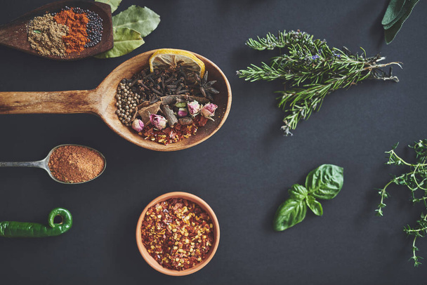 Mixing it up in the kitchen. High angle shot of an assortment of herbs and spices - Fotó, kép