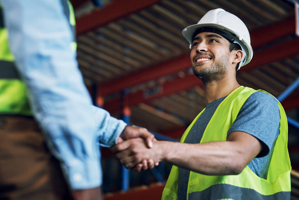 Happy man, architect and handshake for construction, building or hiring in teamwork or partnership on site. Business people shaking hands in recruiting, architecture agreement or contractor deal. - 写真・画像