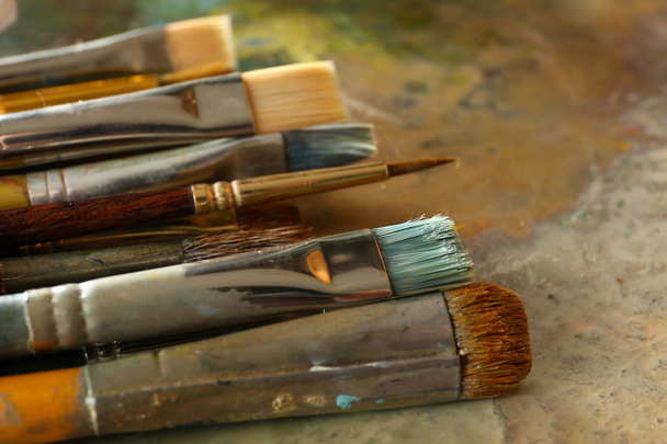 Different brushes on wooden palette - Photo, Image