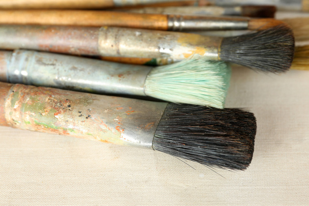 Different paintbrushes on fabric background - Foto, Bild
