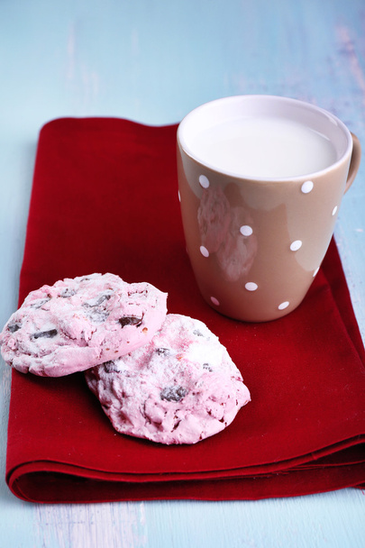 Pink cookies and cup with milk on table close-up - Foto, Imagen