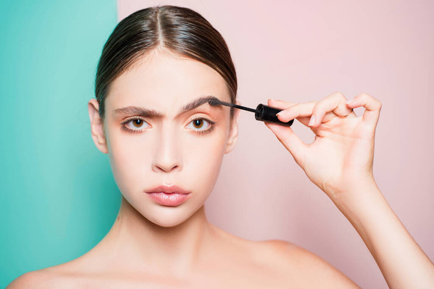 Young beautiful woman does natural brow makeup. Portrait of girl with professional makeup and perfect smooth healthy skin. Very naturalinvisible make up for looking nice - 写真・画像