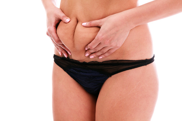 Mulher belisca gordura na barriga
 - Foto, Imagem