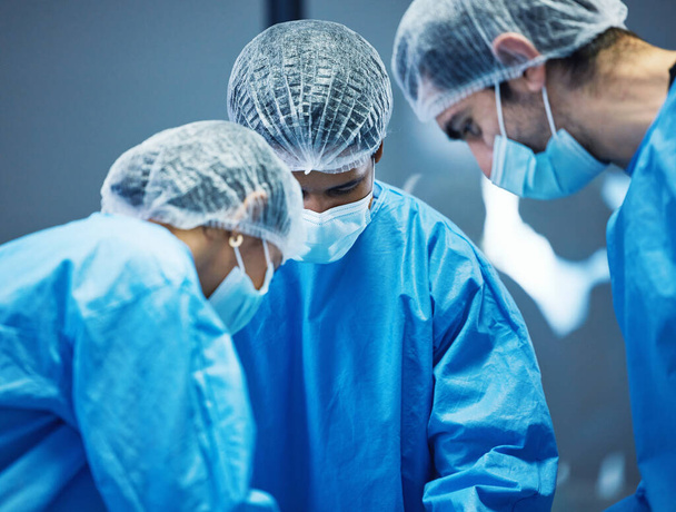 Team of doctors n surgery, healthcare and surgical procedure start with PPE and collaboration in operation theatre in hospital. Medical, health insurance and safety gear with surgeon people in clinic. - Foto, Imagen