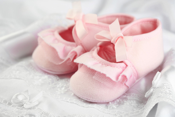 Pink baby boots on cloth close-up - Photo, Image