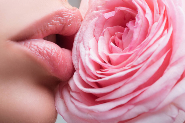 Beautiful woman lips with rose. Beautiful lips. Beauty. Cosmetic lips. Cosmetic beauty - Photo, Image