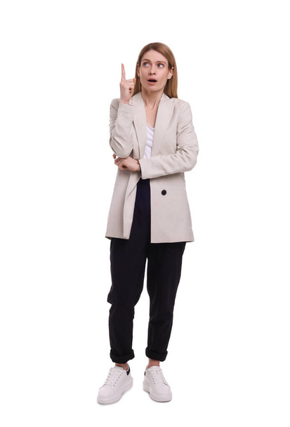 Beautiful business woman pointing at something on white background - Valokuva, kuva