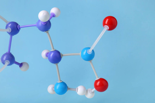 Molecule of phenylalanine on light blue background, closeup. Chemical model - Zdjęcie, obraz