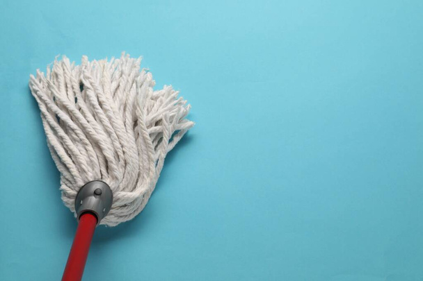 Mop with plastic handle on light blue background, top view. Space for text - Fotografie, Obrázek