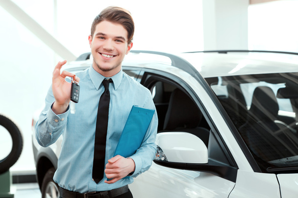 Handsome young man in dealership - Photo, Image