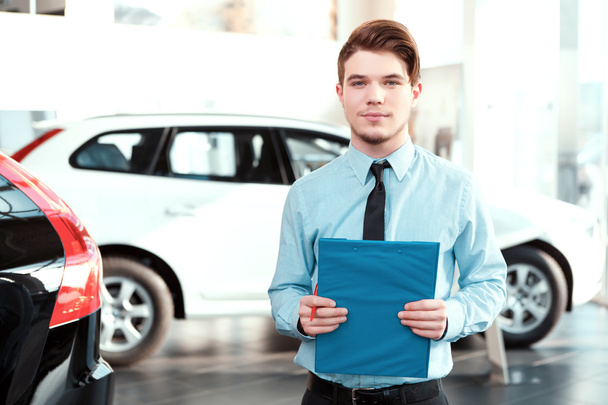 Handsome young man in dealership - Foto, immagini