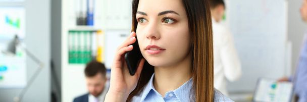 Portrait of beautiful businesswoman with phone in office. Business consultant and stay connected concept - Photo, Image