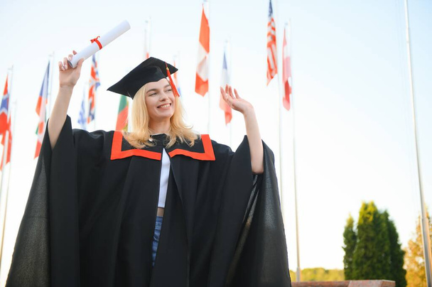 Portrait of a happy woman on her graduation day at university. Education and people - 写真・画像