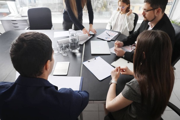 Group of people working on business plan at table in office - Photo, Image