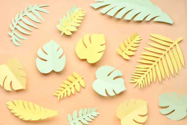 Paper tropical leaves on orange background - Фото, зображення