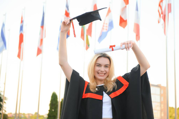 Portrait of a happy woman on her graduation day at university. Education and people - Photo, image