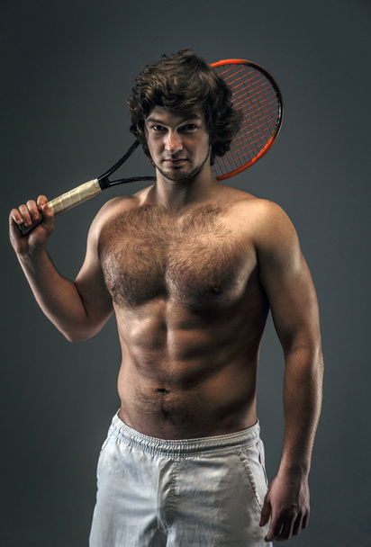 Male with naked torso and tennis racket. - Foto, Bild