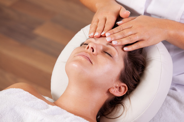 Young beautiful woman getting facial massage - Foto, imagen