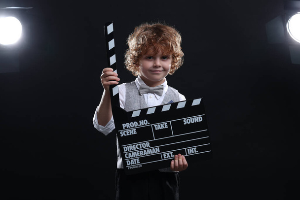 Cute boy with clapperboard on stage. Little actor - Foto, Imagem